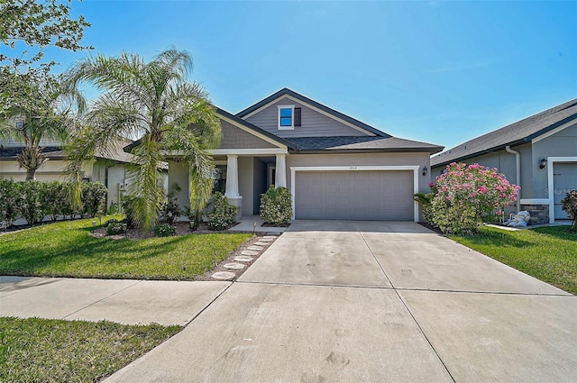 view of front of house with a garage, driveway, stucco siding, and a front yard