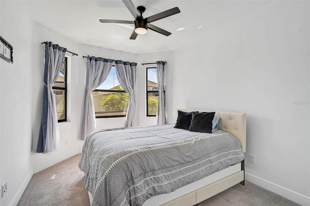 bedroom featuring carpet floors, baseboards, and ceiling fan