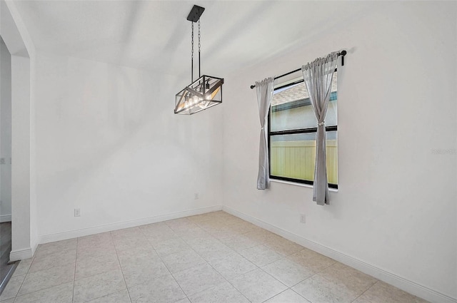 unfurnished dining area with arched walkways, baseboards, and light tile patterned floors