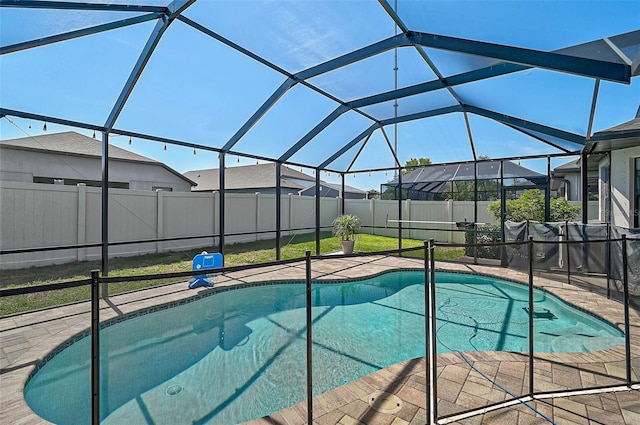 view of swimming pool featuring fence, a patio, and glass enclosure