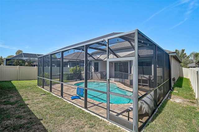 view of swimming pool featuring glass enclosure and a patio area