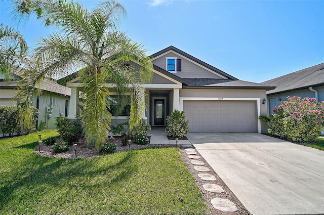 view of front of home with a garage, concrete driveway, a front lawn, and stucco siding