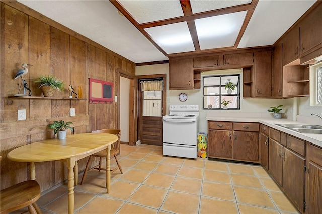 417 Shore Rd Unit A & B, Nokomis, FL 34275 - kitchen featuring white electric stove, open shelves, a sink, light countertops, and wooden walls