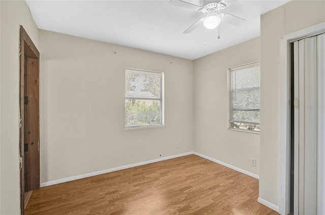417 Shore Rd Unit A & B, Nokomis, FL 34275 - unfurnished bedroom featuring multiple windows, wood finished floors, baseboards, and a closet