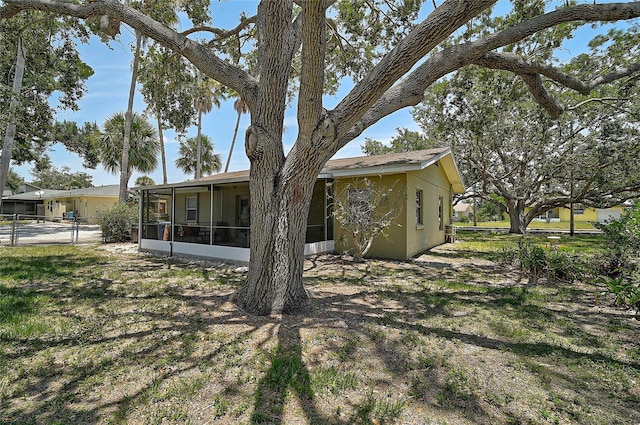 417 Shore Rd Unit A & B, Nokomis, FL 34275 - back of house with a sunroom and stucco siding