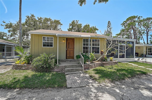 417 Shore Rd Unit A & B, Nokomis, FL 34275 - view of front of house featuring board and batten siding and a sunroom