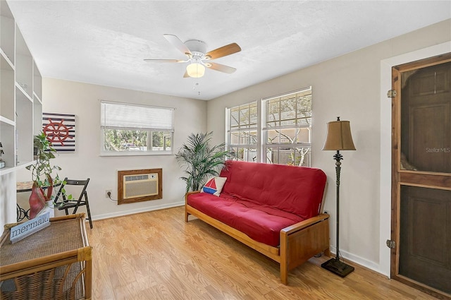 417 Shore Rd Unit A & B, Nokomis, FL 34275 - living area with a wall mounted AC, wood finished floors, ceiling fan, and baseboards