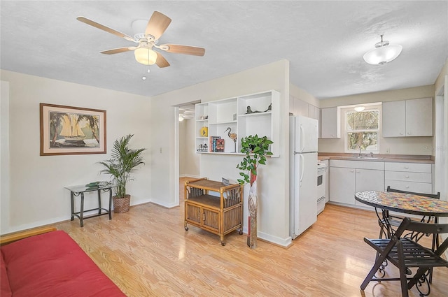 417 Shore Rd Unit A & B, Nokomis, FL 34275 - kitchen featuring light wood-style flooring, a sink, a ceiling fan, baseboards, and white appliances