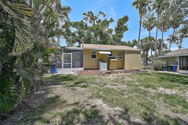 417 Shore Rd Unit A & B, Nokomis, FL 34275 - rear view of house with a sunroom and a yard