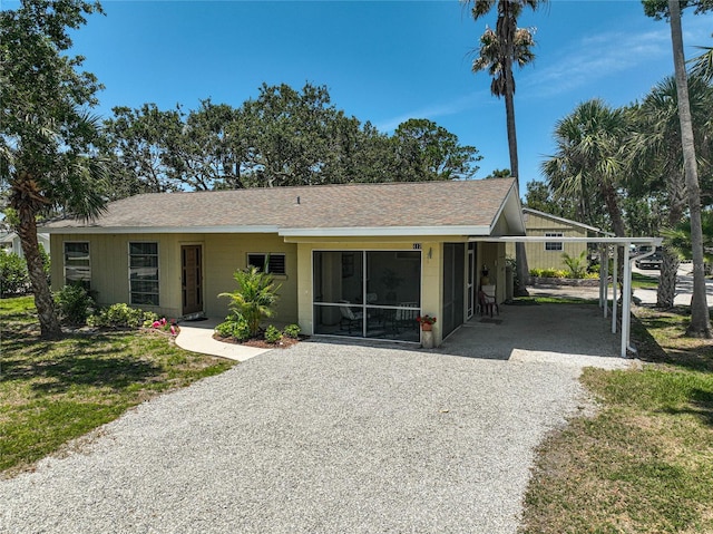 417 Shore Rd Unit A & B, Nokomis, FL 34275 - ranch-style house with driveway, a shingled roof, a carport, and a front yard