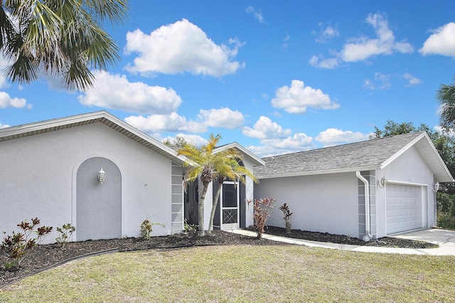 27416 Natal Dr, Punta Gorda, FL 33983 - ranch-style home featuring stucco siding, a garage, a front lawn, concrete driveway, and roof with shingles