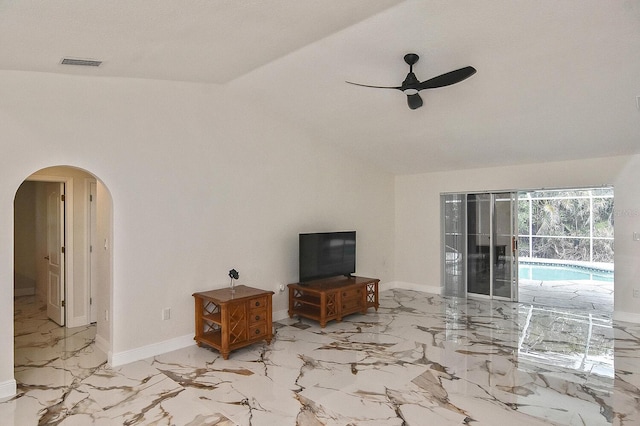 27416 Natal Dr, Punta Gorda, FL 33983 - living area with arched walkways, ceiling fan, vaulted ceiling, marble tiled flooring, and baseboards