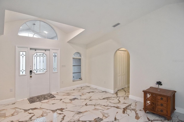 27416 Natal Dr, Punta Gorda, FL 33983 - foyer entrance with light marble finish flooring, arched walkways, and baseboards