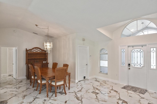 27416 Natal Dr, Punta Gorda, FL 33983 - dining space featuring a chandelier, vaulted ceiling, plenty of natural light, and light marble finish floors