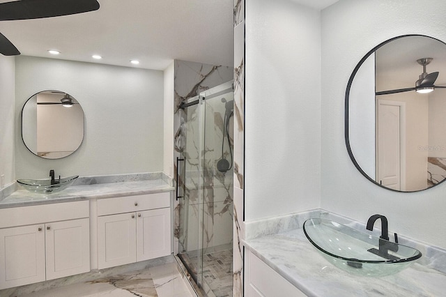27416 Natal Dr, Punta Gorda, FL 33983 - full bath featuring a marble finish shower, marble finish flooring, recessed lighting, and two vanities