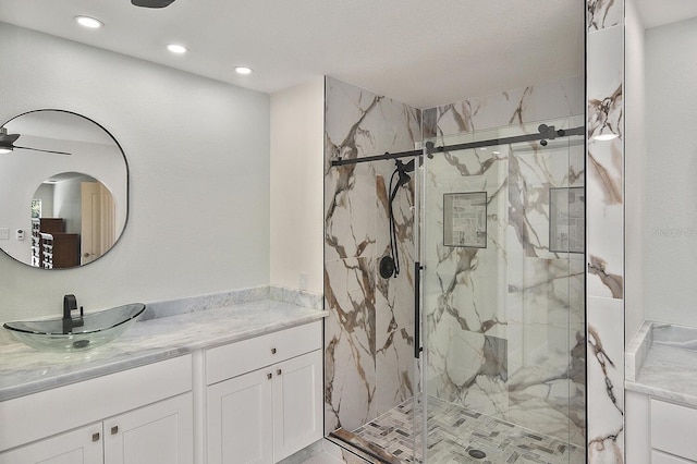 27416 Natal Dr, Punta Gorda, FL 33983 - bathroom featuring a marble finish shower, vanity, recessed lighting, and ceiling fan