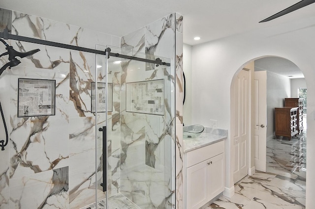 27416 Natal Dr, Punta Gorda, FL 33983 - bathroom with marble tiled floors, a marble finish shower, and vanity