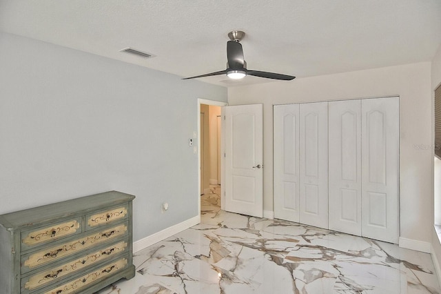 27416 Natal Dr, Punta Gorda, FL 33983 - bedroom with light marble finish flooring, baseboards, a closet, and ceiling fan