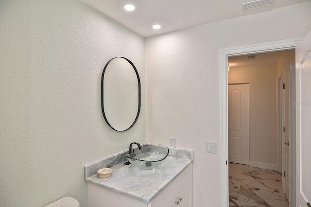 27416 Natal Dr, Punta Gorda, FL 33983 - half bathroom featuring marble look tiles, vanity, and recessed lighting
