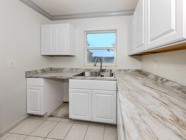 6231 Jordan St, North Port, FL 34287 - kitchen with a sink, ornamental molding, white cabinetry, light countertops, and light tile patterned floors