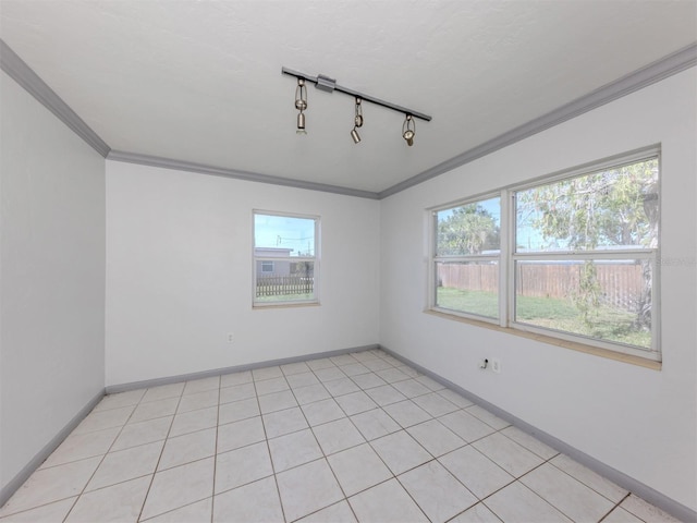 6231 Jordan St, North Port, FL 34287 - empty room featuring crown molding, plenty of natural light, baseboards, and rail lighting