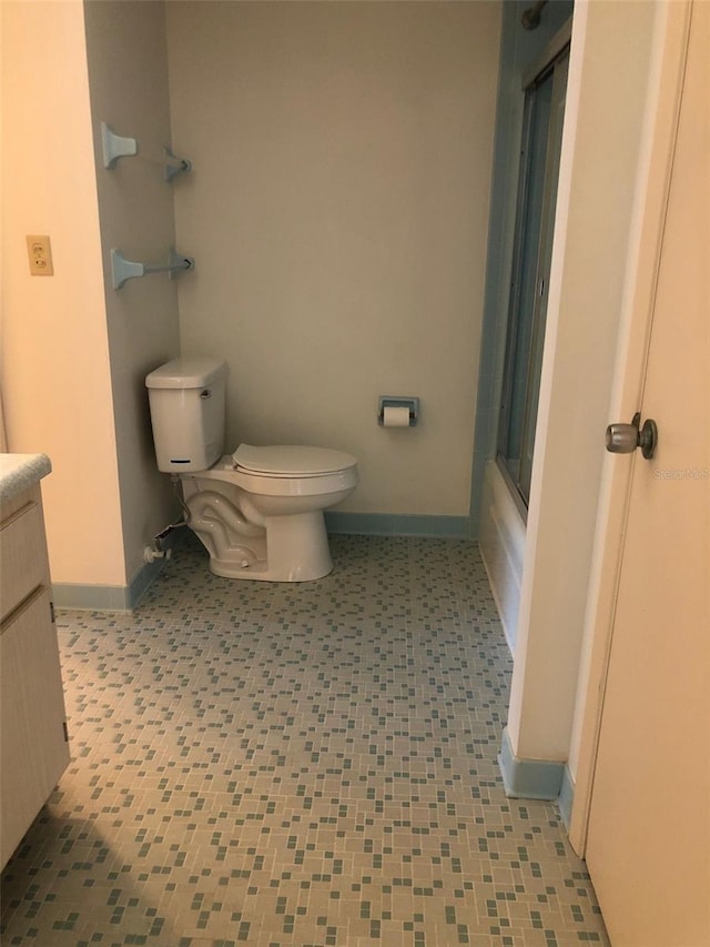512 W Venice Ave Unit 205, Venice, FL 34285 - bathroom featuring toilet, baseboards, an enclosed shower, and vanity