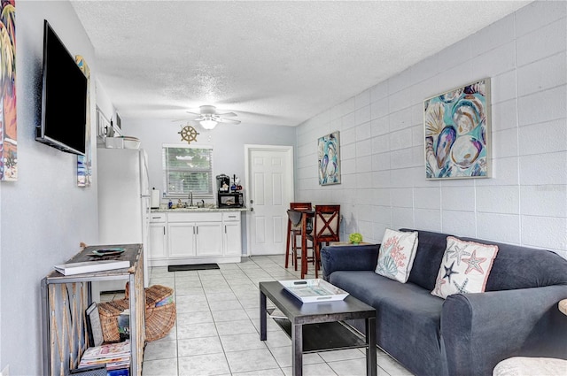 422 Polk Ave, Cape Canaveral, FL 32920 - living room featuring a textured ceiling, a ceiling fan, and light tile patterned floors