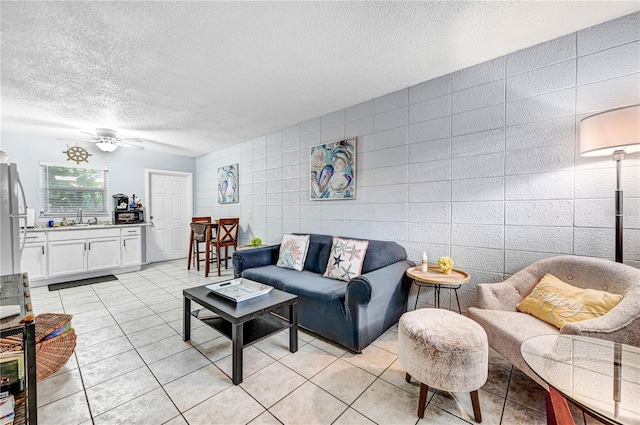 422 Polk Ave, Cape Canaveral, FL 32920 - living room with tile walls, a textured ceiling, light tile patterned flooring, and ceiling fan
