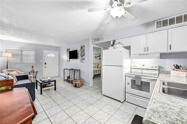 422 Polk Ave, Cape Canaveral, FL 32920 - kitchen featuring white appliances, under cabinet range hood, a sink, light countertops, and white cabinets