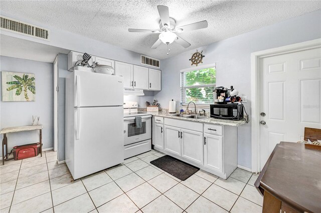 422 Polk Ave, Cape Canaveral, FL 32920 - kitchen featuring white appliances, a sink, under cabinet range hood, white cabinets, and a ceiling fan
