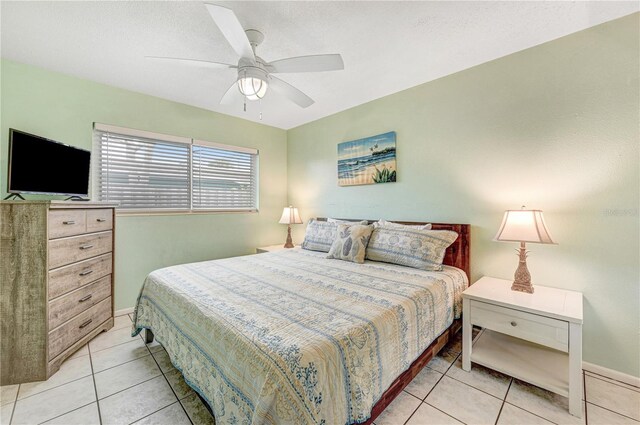 422 Polk Ave, Cape Canaveral, FL 32920 - tiled bedroom featuring ceiling fan and baseboards