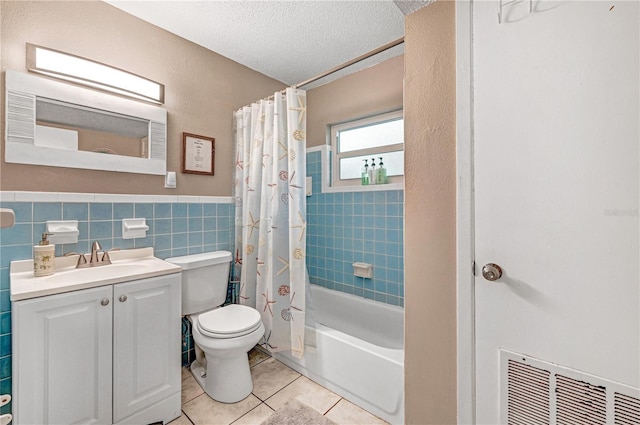 422 Polk Ave, Cape Canaveral, FL 32920 - full bath with tile patterned flooring, toilet, a textured ceiling, vanity, and shower / tub combo