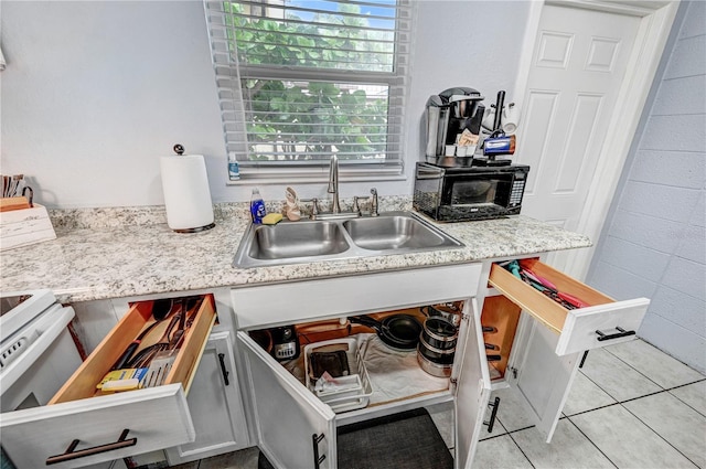 422 Polk Ave, Cape Canaveral, FL 32920 - kitchen with a sink, light tile patterned flooring, and electric stove
