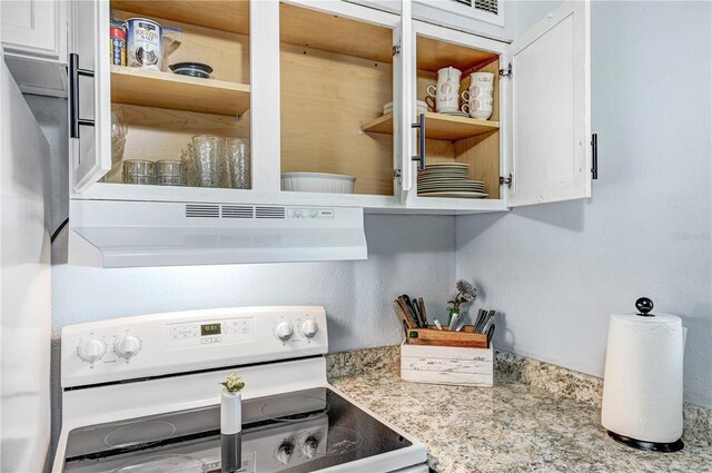 422 Polk Ave, Cape Canaveral, FL 32920 - kitchen view of electric range, under cabinet range hood, open shelves, and white cabinetry