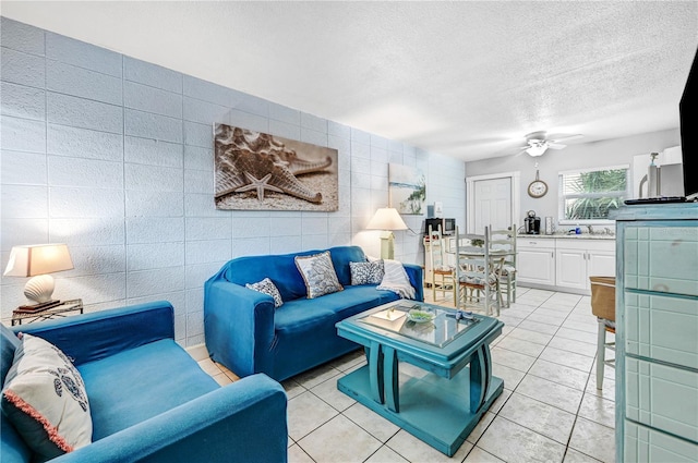 422 Polk Ave, Cape Canaveral, FL 32920 - living room with tile walls, light tile patterned floors, a textured ceiling, and ceiling fan