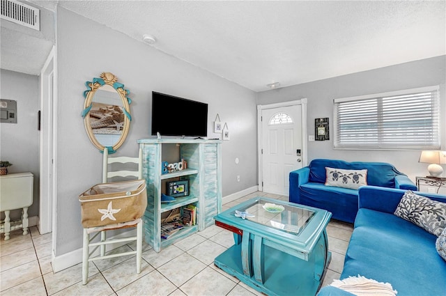 422 Polk Ave, Cape Canaveral, FL 32920 - tiled living room with a textured ceiling and baseboards