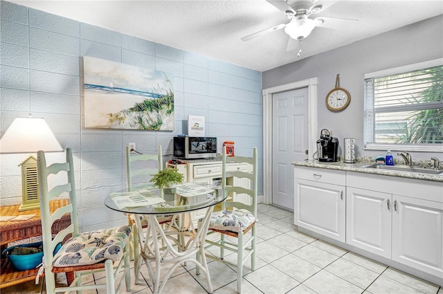 422 Polk Ave, Cape Canaveral, FL 32920 - dining room featuring tile walls, light tile patterned flooring, ceiling fan, and a textured ceiling