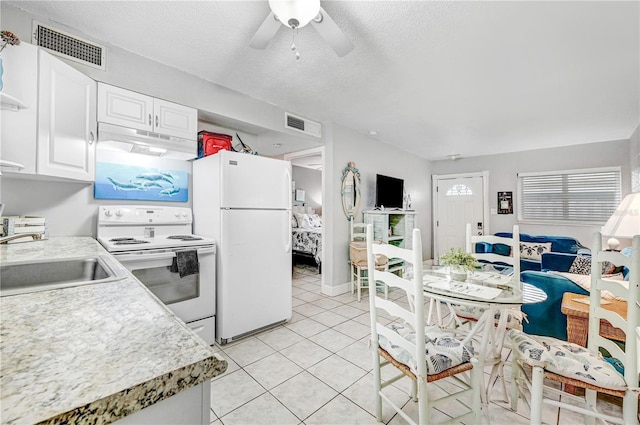 422 Polk Ave, Cape Canaveral, FL 32920 - kitchen with white appliances, a sink, under cabinet range hood, light countertops, and a textured ceiling