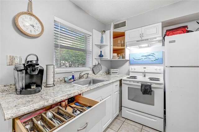 422 Polk Ave, Cape Canaveral, FL 32920 - kitchen with white appliances, under cabinet range hood, a sink, white cabinets, and light countertops