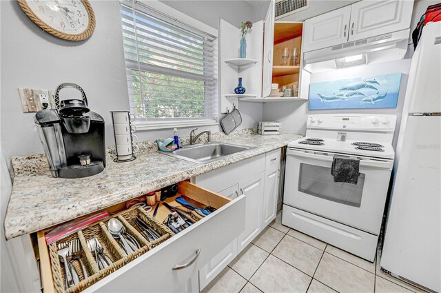 422 Polk Ave, Cape Canaveral, FL 32920 - kitchen featuring white appliances, under cabinet range hood, a sink, white cabinets, and light tile patterned floors