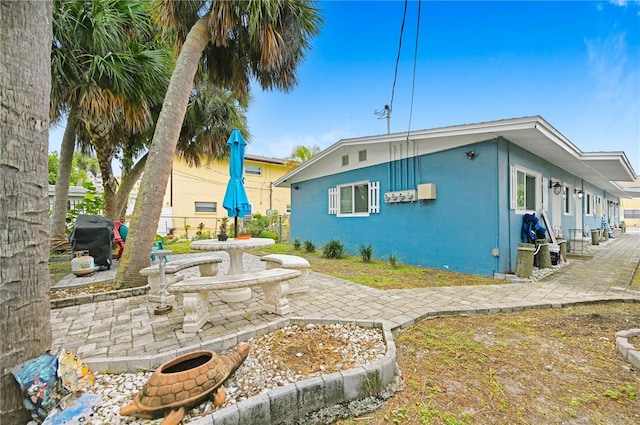 422 Polk Ave, Cape Canaveral, FL 32920 - view of home's exterior featuring a patio and stucco siding