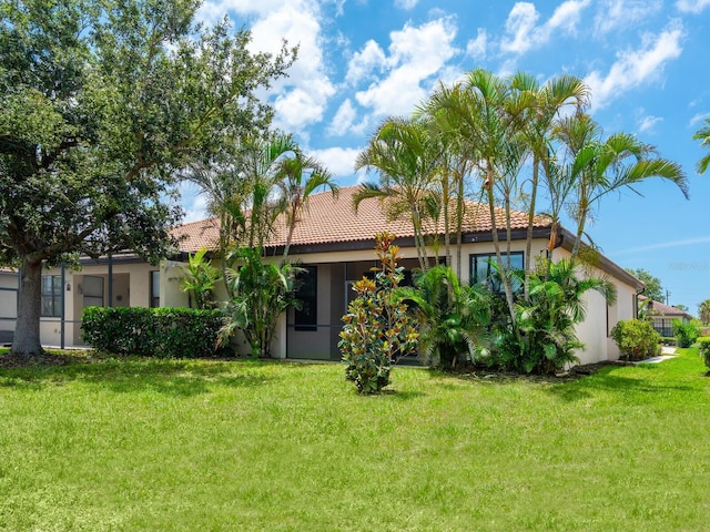 1493 Maseno Dr, Venice, FL 34292 - rear view of house with stucco siding and a lawn