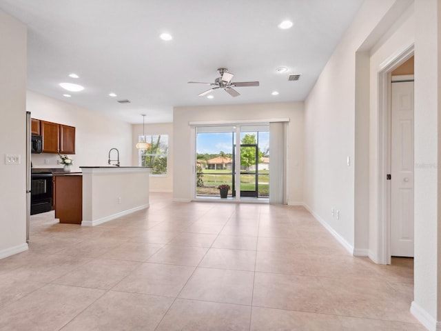 1493 Maseno Dr, Venice, FL 34292 - unfurnished living room with ceiling fan, recessed lighting, baseboards, and light tile patterned flooring