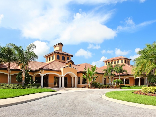1493 Maseno Dr, Venice, FL 34292 - view of front of property with stucco siding, a tiled roof, and curved driveway