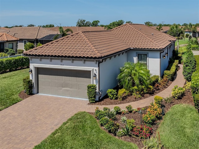 5853 Semolino St, Nokomis, FL 34275 - mediterranean / spanish home with an attached garage, driveway, stucco siding, a front lawn, and a tiled roof