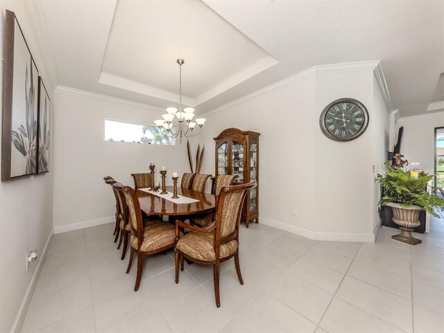 5853 Semolino St, Nokomis, FL 34275 - dining space featuring a chandelier, baseboards, light tile patterned floors, a raised ceiling, and ornamental molding