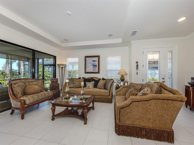 5853 Semolino St, Nokomis, FL 34275 - living area with a tray ceiling, light tile patterned flooring, and crown molding