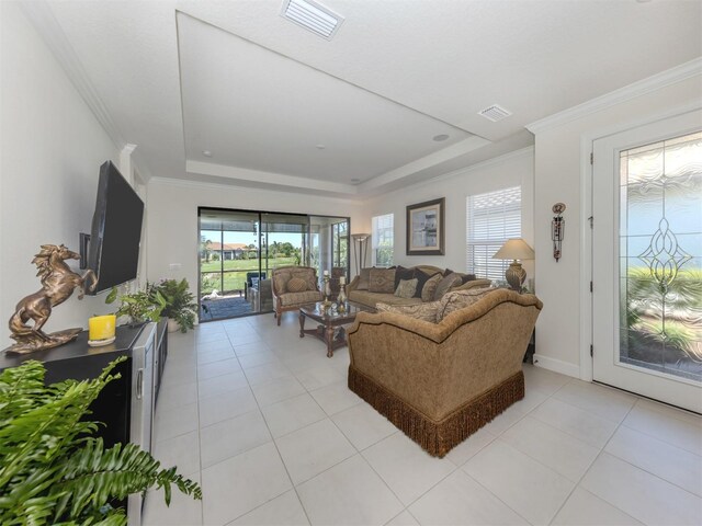 5853 Semolino St, Nokomis, FL 34275 - living room featuring a tray ceiling, light tile patterned flooring, and ornamental molding