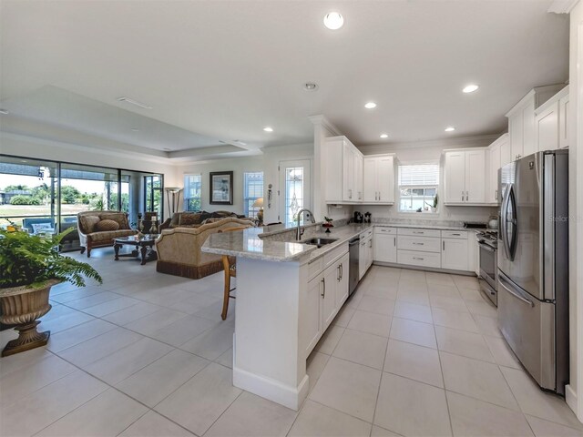 5853 Semolino St, Nokomis, FL 34275 - kitchen with appliances with stainless steel finishes, open floor plan, a sink, a peninsula, and light tile patterned floors