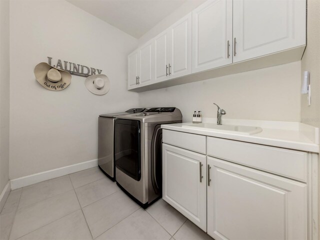 5853 Semolino St, Nokomis, FL 34275 - laundry area featuring cabinet space, washer and dryer, baseboards, and light tile patterned floors